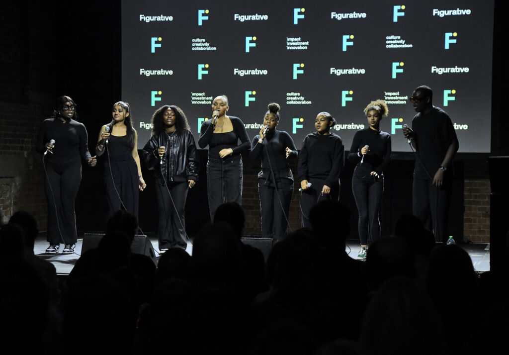 a group of people singing on a stage